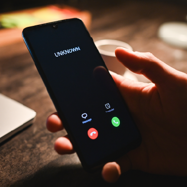 IMAGE: Person holding phone with unknown number calling