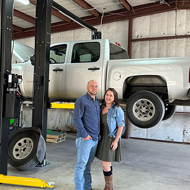 IMAGE: David and Julie Doughty standing inside Doughty Automotive