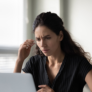 IMAGE: Concerned woman looking at a laptop