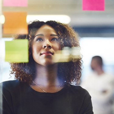 a woman looking at a vision board