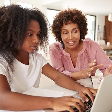 IMAGE: Mother and child working on a laptop together