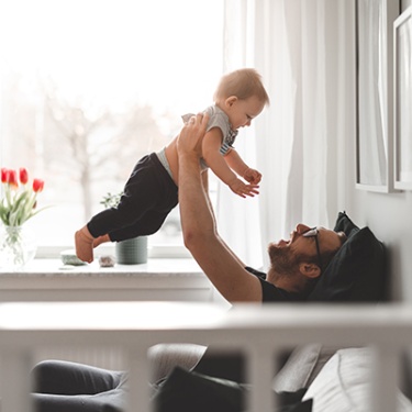 father holding his child in the air