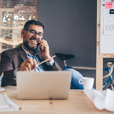 IMAGE: man wearing glasses sitting at his desk