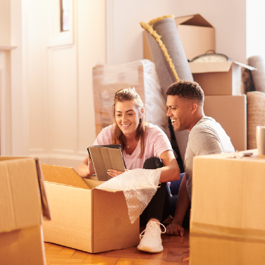 IMAGE: Couple unpacking boxes inside new home
