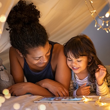 a mother and daughter viewing a tablet