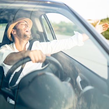 a man happy riding in his car