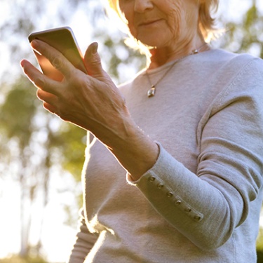 an elderly woman viewing her mobile device