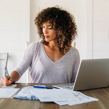 a woman working on her laptop going over her budget