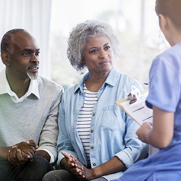 IMAGE: Older couple listening to a health care professional