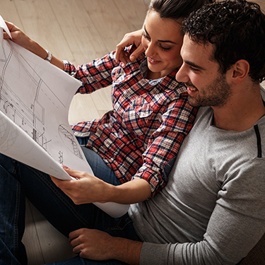 IMAGE: Couple looking at house architectural plans