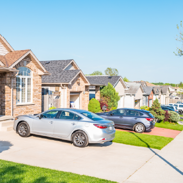 IMAGE: Neighborhood with cars in driveways
