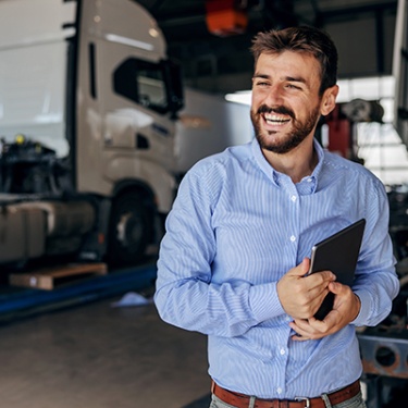 business man at an mechanic shop