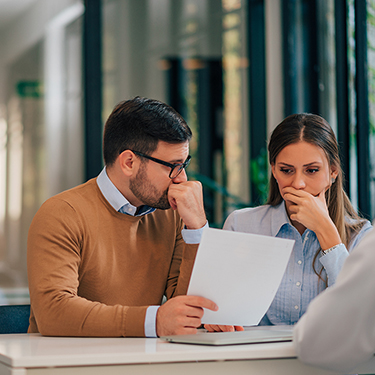 IMAGE: Worried couple looking at document