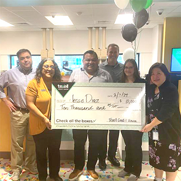 IMAGE: Jesse Diaz redeems million BONUS Reward Points with Cedar Park branch staff members